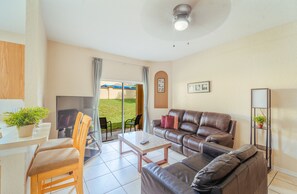 Relax in this stylish living area with a comfortable sofa, dining table, and flat-screen TV.
