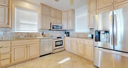 Upscale beachfront home with private hot tub, grill, on-site pools, gym, dogs OK