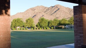 A view of a grassy field with trees and a mountain in the background. - Spacious Buckeye Vacation Home (Buckeye)