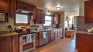 Enjoy cooking in this well-equipped kitchen with a stove, oven, and sink, plus ample storage in the cabinetry.