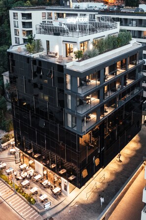A modern hotel with multiple balconies, outdoor seating, and a rooftop terrace. - City Hotel Dubrovnik (Dubrovnik)
