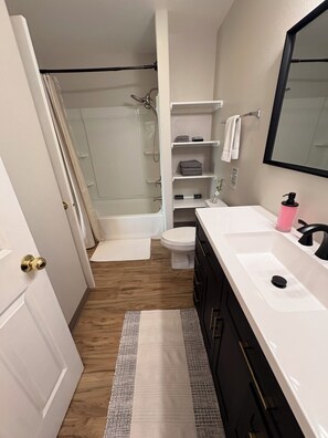 A bathroom with a shower, toilet, and sink. - Family Getaway - Central Location - No Chores (Anchorage)