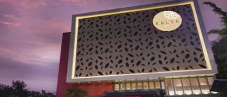 A modern hotel with a large facade featuring a patterned design.