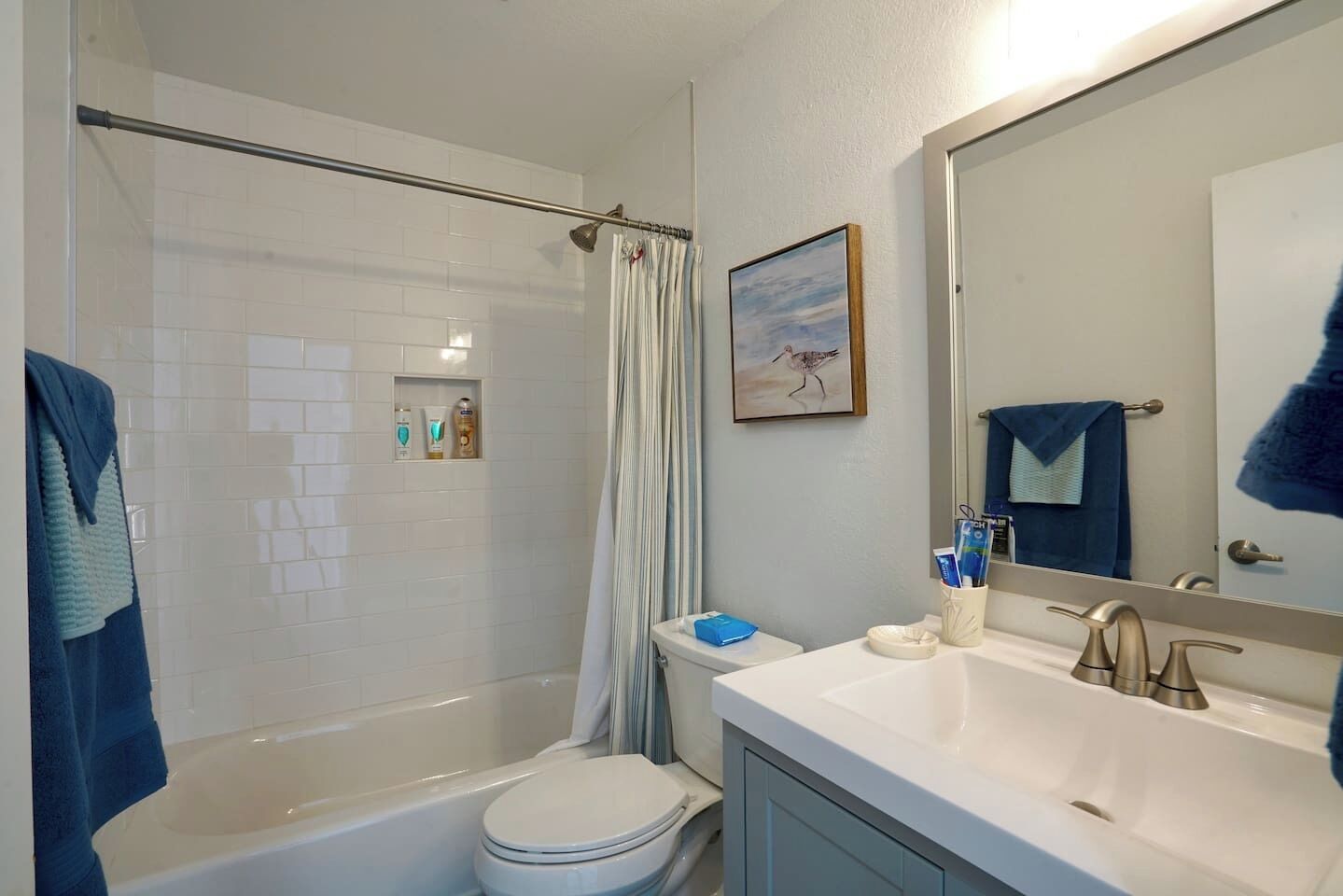 A bathroom with a bathtub, toilet, and sink.