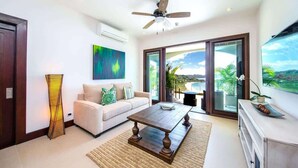 A modern living room with a sofa, coffee table, and artwork on the wall. - 360 Splendor 205-Condo with Breakfast Included (360 Splendor)