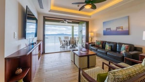 A spacious living area with a balcony, a sofa set, a coffee table, and a television. - 360 Splendor 207F- 3 BR Condo, Breakfast Included (360 Splendor)