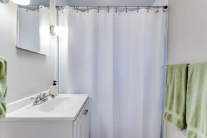 A bathroom with a white sink, a mirror, and a shower curtain. - Beautiful 2 bdrm, 1 Bath 4 blocks from The U of O, (Eugene)