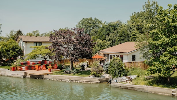 A residential area with a house, a dock, and a small boat.