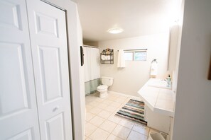 A bathroom with a toilet, sink, and shower area. - Cozy Turns- Vail/ Minturn Colorado (Minturn)