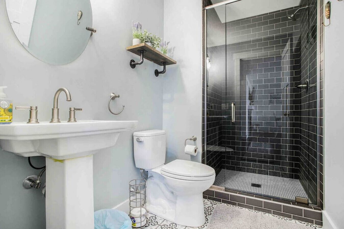 A bathroom with a white sink, toilet, and shower.
