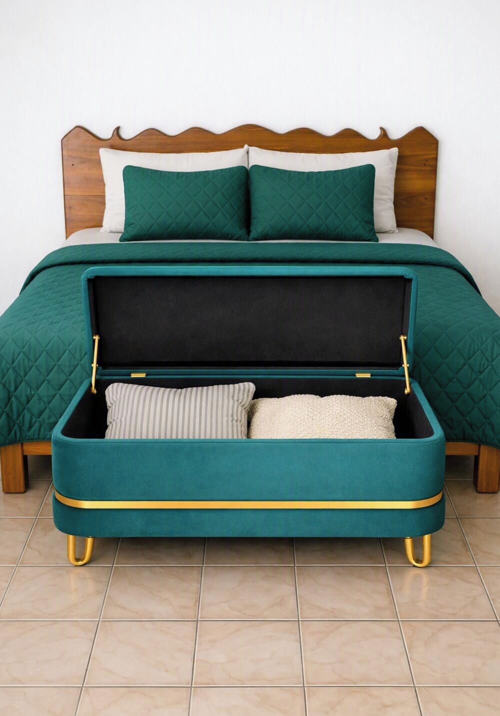 A bed with a teal quilted bedspread, a wooden headboard, and a suitcase with a black interior and teal exterior.