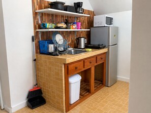 A compact kitchenette with a microwave, a coffee maker, a sink, and a dish rack. - Dreams Negril at Coletta's Restaurant - Studio (Negril)