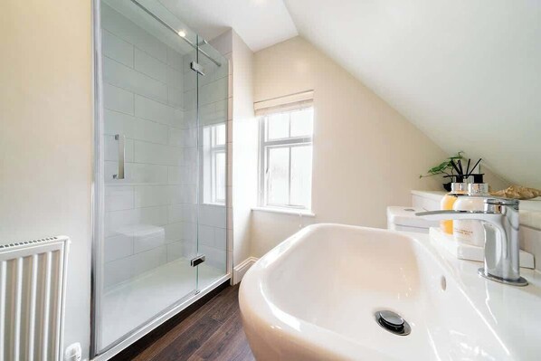 Shower, hair dryer, towels, toilet paper