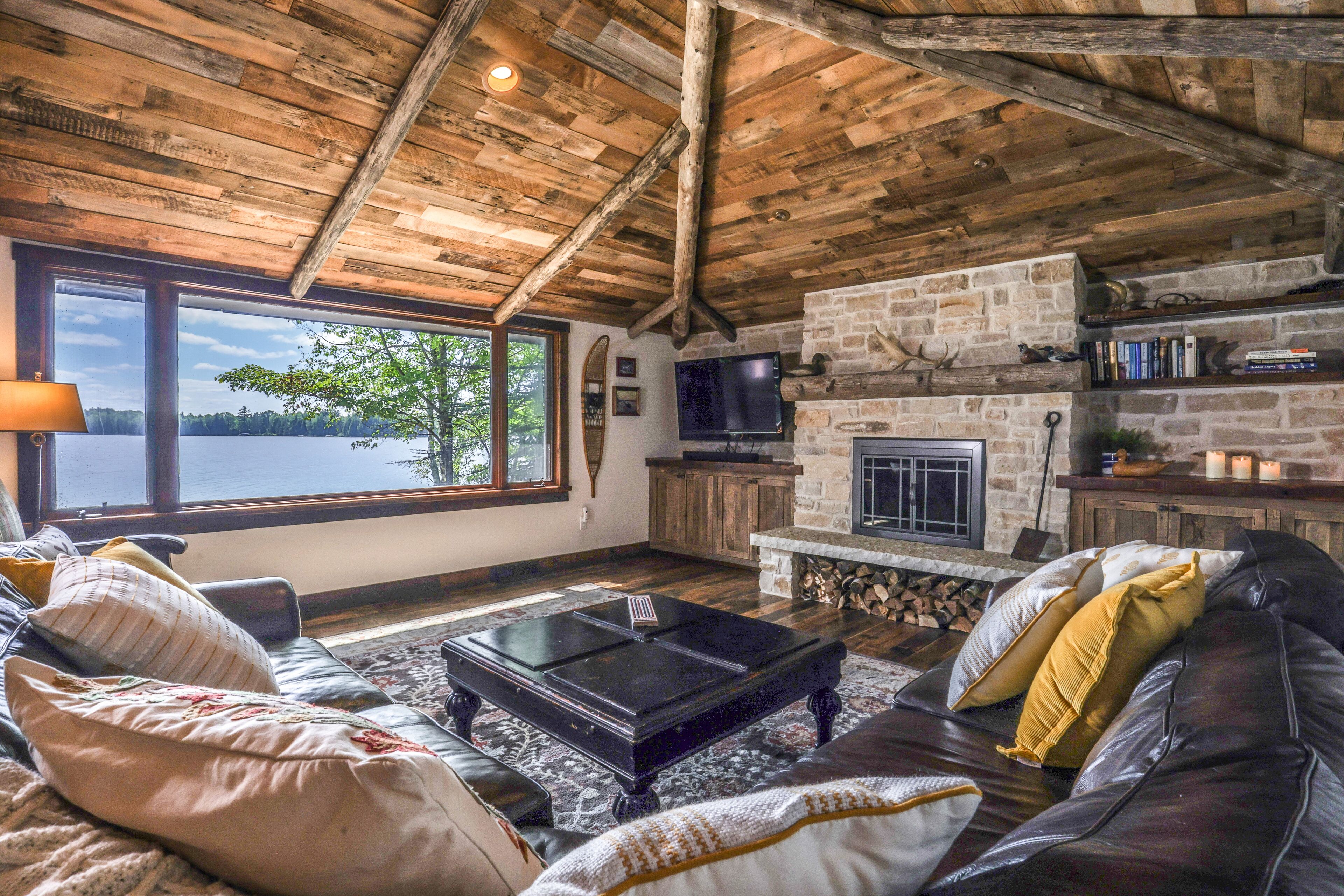 Lakefront home on snowmobile trail with kayaks/SUP, fireplace, game room & AC