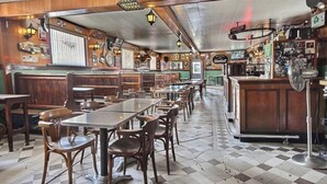 A diner with wooden booths and tables, a counter with a fan, and various memorabilia on the walls. - Grand Central Hotel Richmond (Richmond)