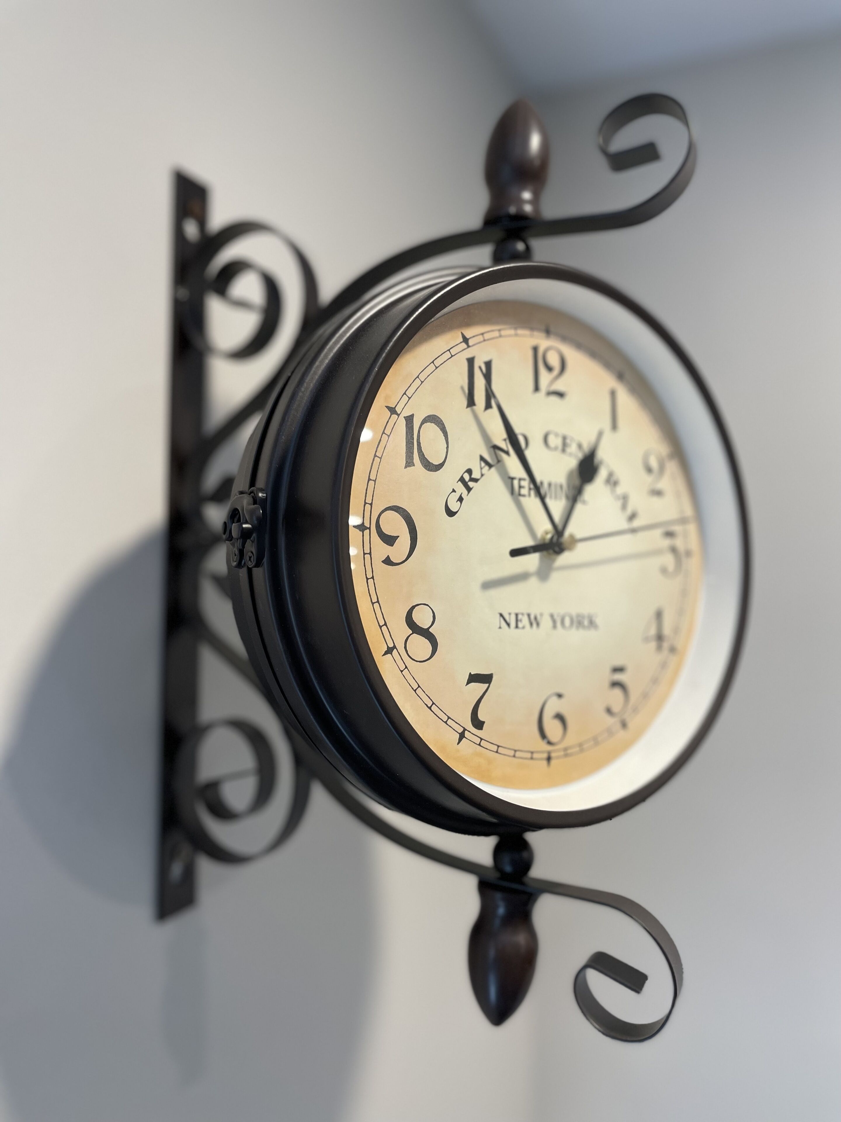 A wall-mounted clock with a classic design, featuring the brand name "Grand Central" and the location "New York."