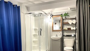 A modern bathroom with a glass shower enclosure, a sink, and a toilet. - Grand Central Hotel Richmond (Richmond)