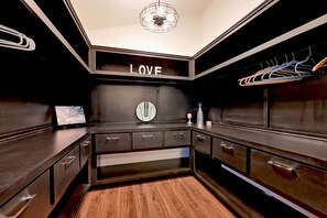 Enjoy cooking in this stylish kitchen with a central island, sleek cabinetry, and a large mirror.