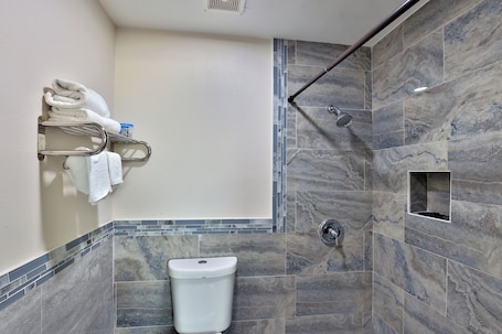 A modern bathroom with a shower, a toilet, and a towel rack.. Monterrey Motel Padre Island, Corpus Christi By Oyo