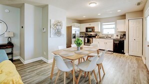 A modern kitchen with white cabinets, a microwave, and a dishwasher. - 5 Mins to Ruoff+Dog Friendly+Fenced yard+Fast WiFi (Noblesville)