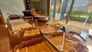 A buffet with various food items including bread, pastries, and a large pot of soup. - Ilusion Flats Aconchego de Ponta Negra (Natal)