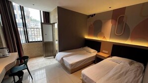 A hotel room with two beds, a desk with a chair, a small table, and a window with curtains. - shangyoucsgy (Taishan)