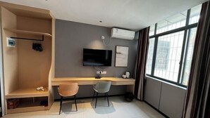 A modern room with a desk, two chairs, a TV, and a window with curtains. - shangyoucsgy (Taishan)