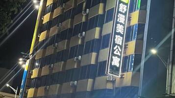 A multi-story building with illuminated signage.