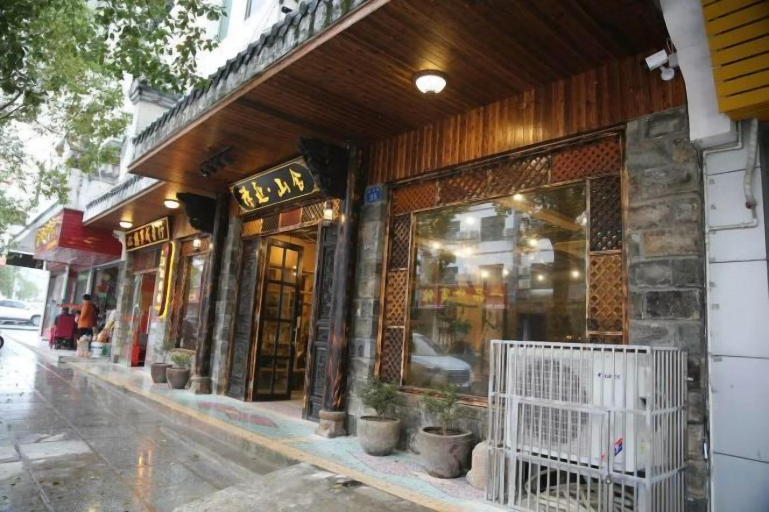 A building with a traditional facade, a wooden entrance, and a sign with foreign characters.