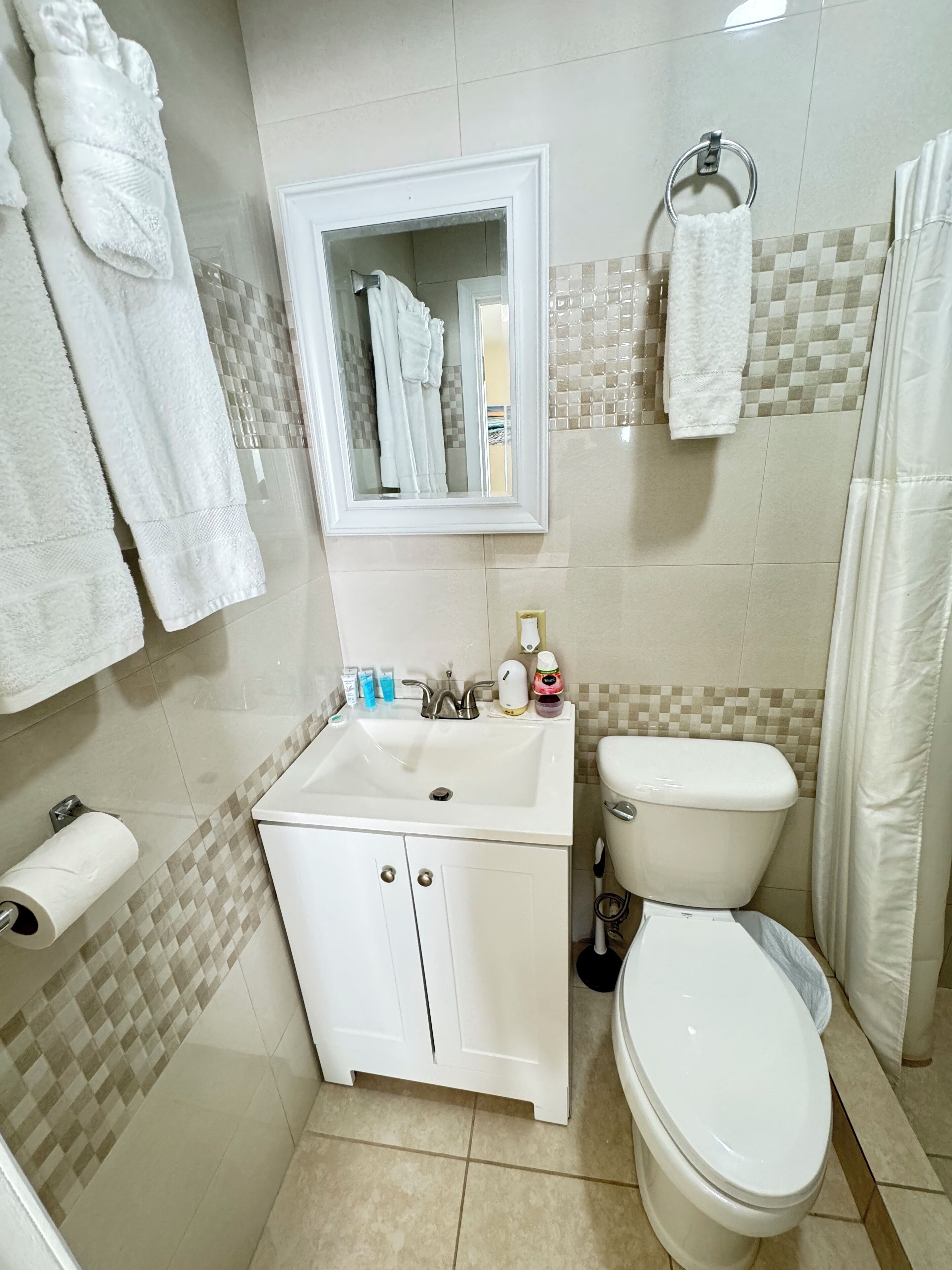 A bathroom with a white sink, toilet, and towel rack.