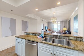 Enjoy cooking in this well-equipped kitchen with a double sink, dishwasher, and ample space for dining and socializing.