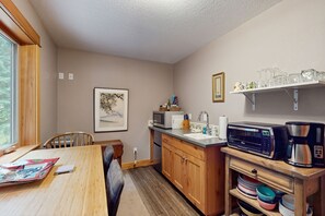 Fridge, microwave, coffee/tea maker, cookware/dishes/utensils