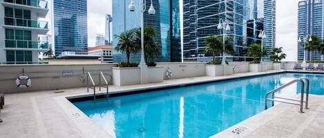 A swimming pool with a view of tall buildings in the background.