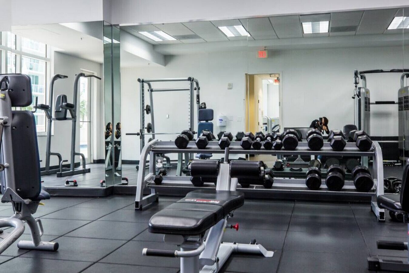 A gym with various exercise equipment, including dumbbells and weight machines.