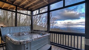 A hot tub on a wooden deck with a view of a forest and mountains. - Nearby hikes + a hot tub! - Appalachian Sunrise (Blue Ridge)