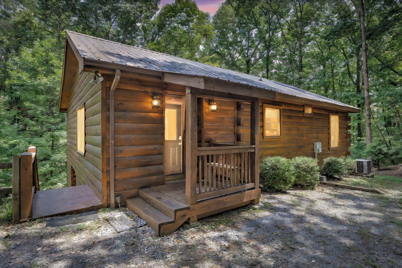 A small wooden cabin with a porch, a door, and a window.