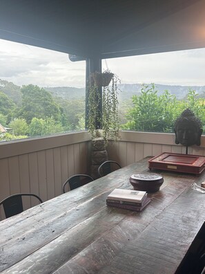 A wooden table with chairs, a hanging plant, a Buddha statue, and a book titled "Reclaiming Style". - Unique modern, spacious, clean large 3 bedroom + study  in beautiful Blackwood (Blackwood)