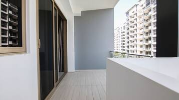 A balcony with a view of high-rise buildings.