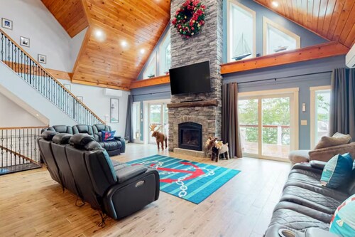 Luxurious waterfront home with deck, firepit, hot tub, fireplace, & pool table