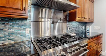 Luxurious waterfront home with deck, firepit, hot tub, fireplace, & pool table