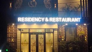 A building with a sign reading "UDIKSH RESIDENCY & RESTAURANT" and a welcome sign at the entrance. - Udiksh Hotel and Restaurants (Rohtak)