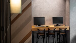 A modern workspace with two monitors, a wooden desk, and four black chairs. - Royal Group Hotel  Xiong Zhong  Branch (Kaohsiung)