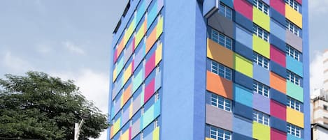 A multi-story hotel with a colorful facade, featuring a prominent sign for the Royal Hotel.