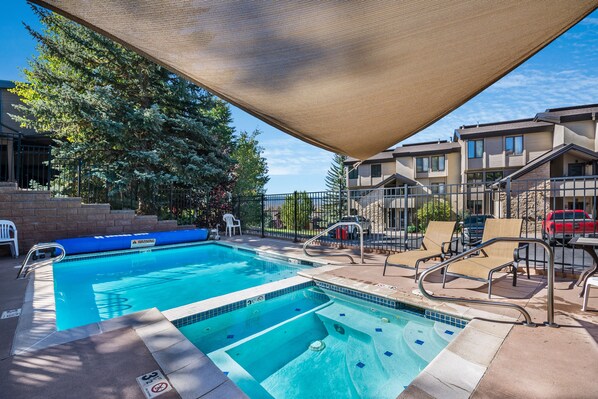Relax by the pool surrounded by a shaded area and lounge chairs.