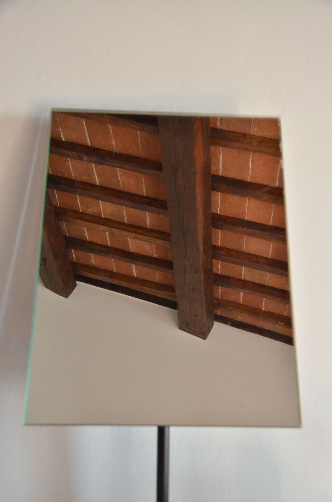 A wooden ceiling structure with a brick pattern.