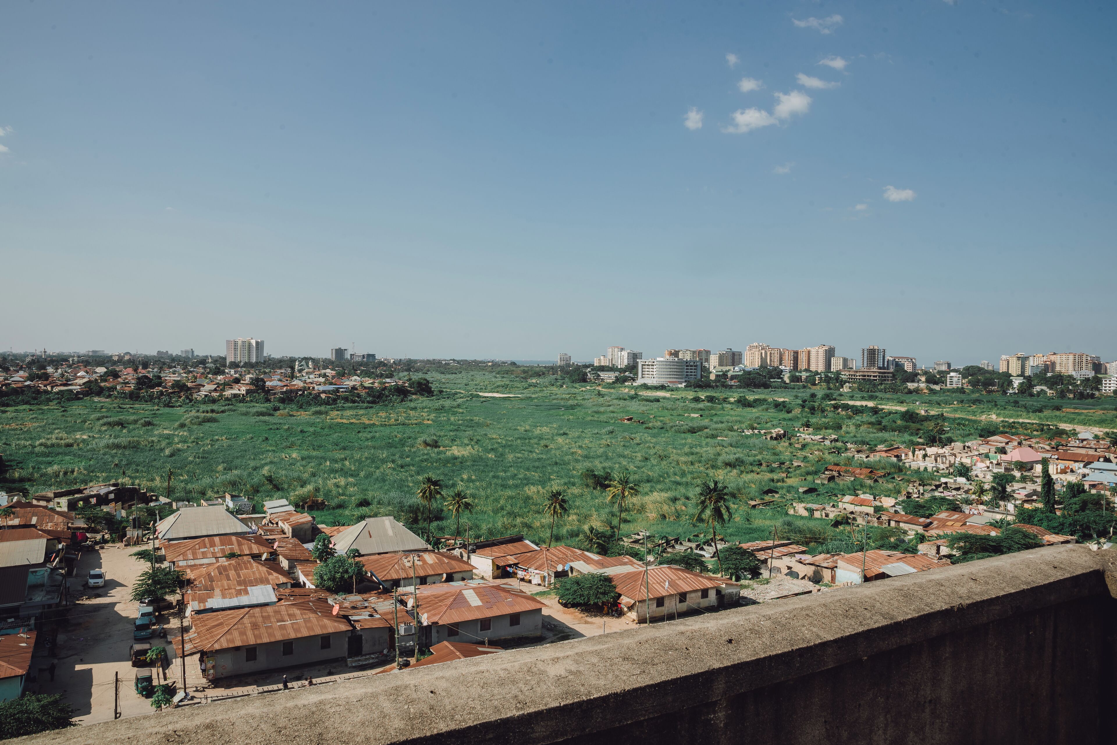 A residential area with houses and a distant city skyline.