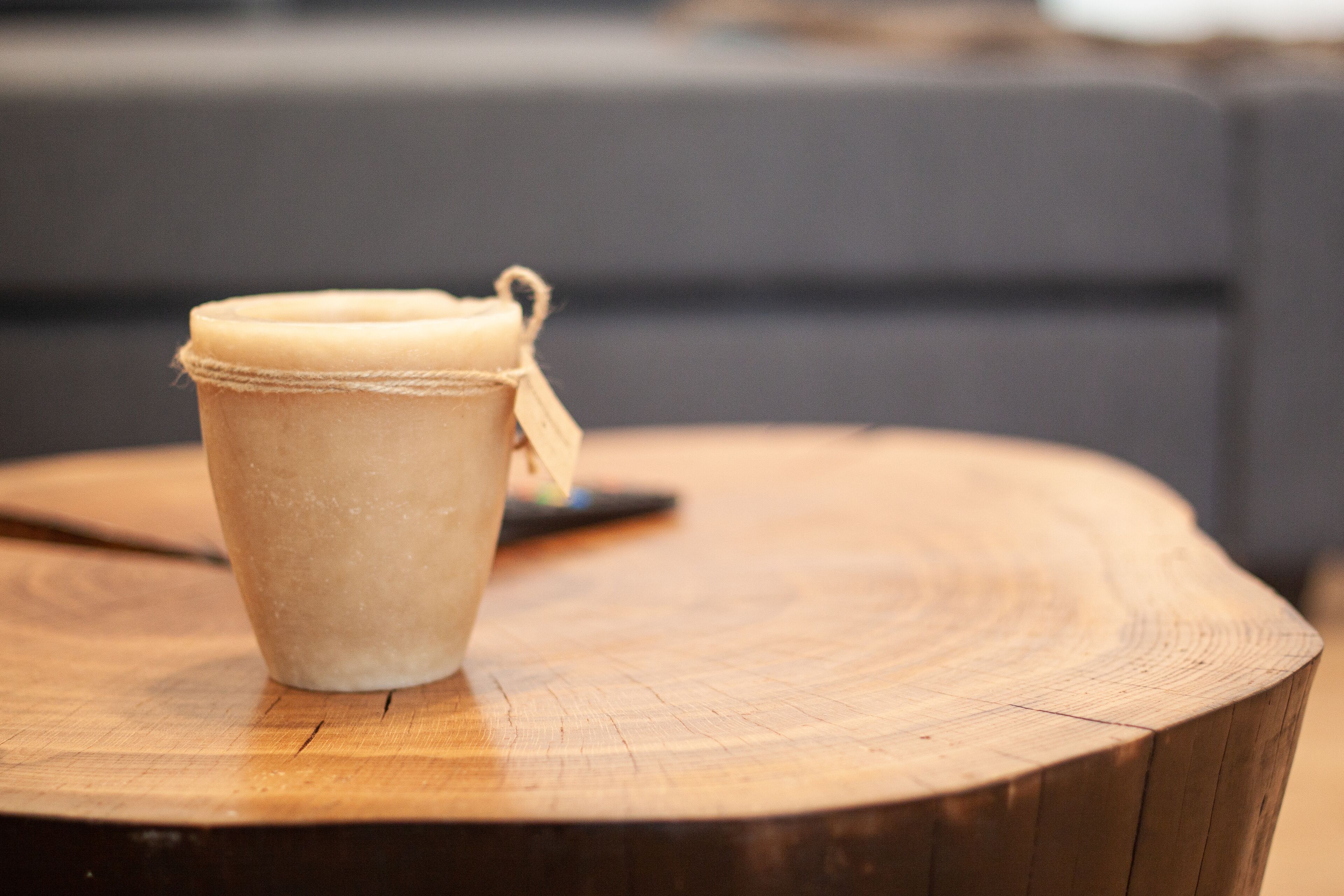 A wooden table with a cup on it.