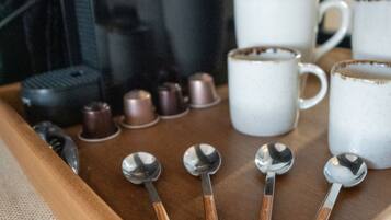 A tray with coffee cups and spoons.