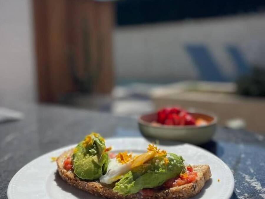 A plate with a sandwich on a table.