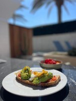 A plate with a sandwich on a table.